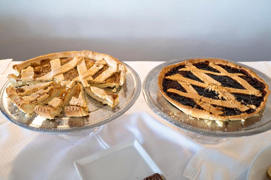two pies sitting on glass plates on a table at Park Hotel Cilento in Marina di Camerota