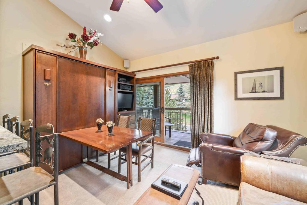 a living room with a table and a couch at Lodge at Lionshead 310 in Vail