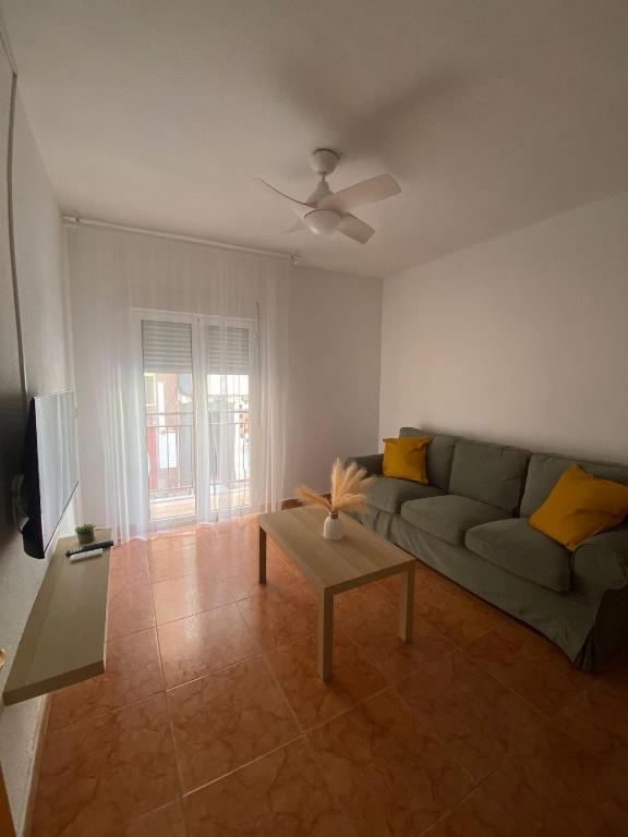 a living room with a couch and a table at Corazón de Santa Pola in Santa Pola