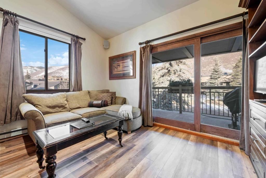 a living room with a couch and a large window at Lodge at Lionshead 340 in Vail