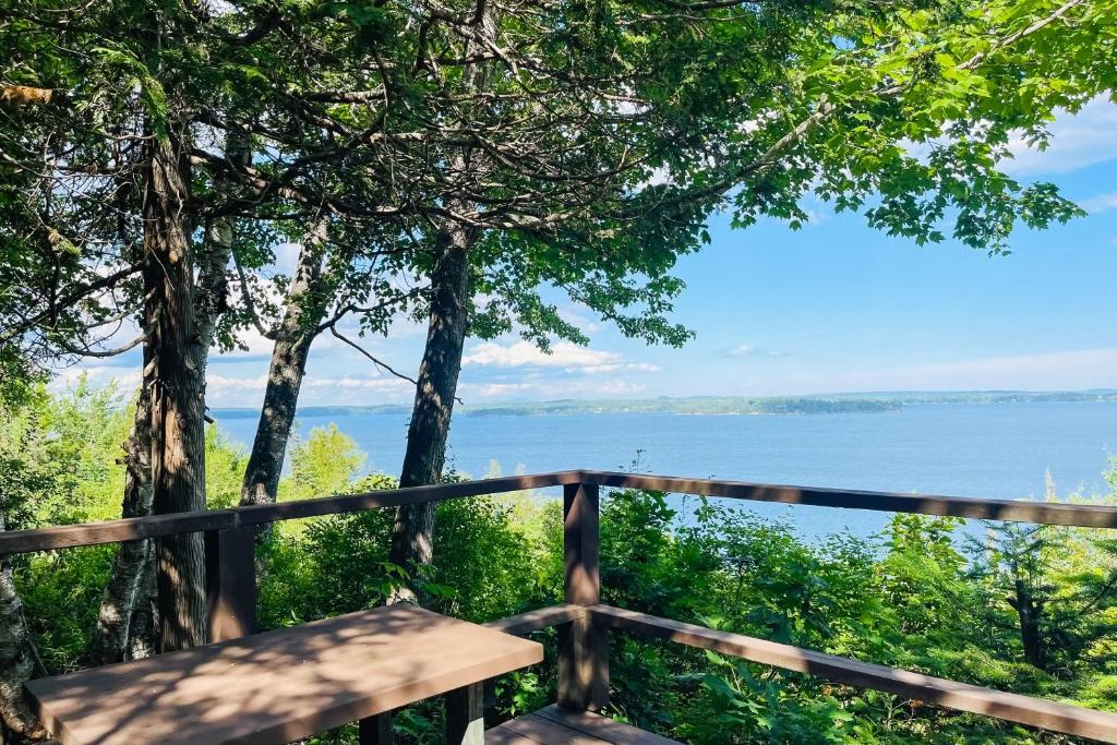 a bench on a balcony overlooking the water at Evergreen in Northport