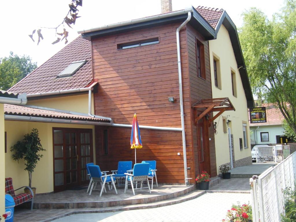 une maison avec des chaises et un drapeau sur une terrasse dans l'établissement Veress Vendégház, à Hajdúböszörmény