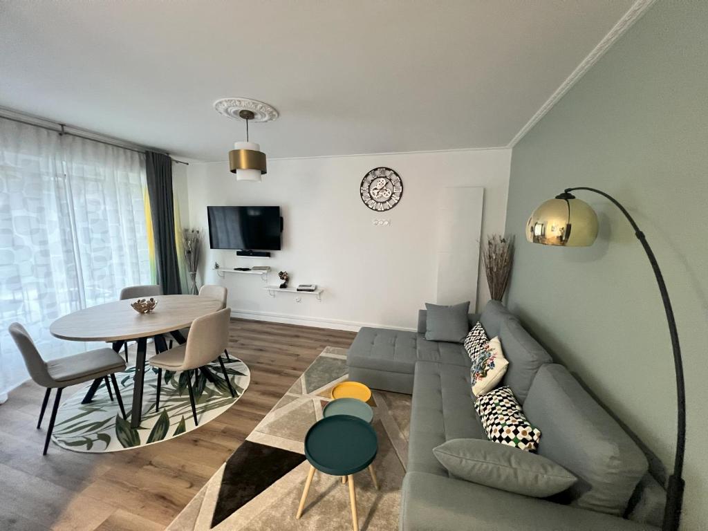 a living room with a couch and a table at Belle maison avec jardin ! in Bezannes-les-Reims