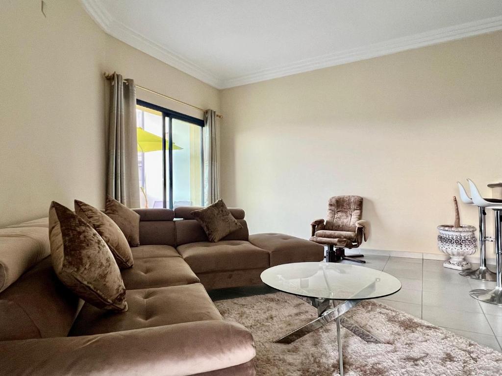 a living room with a couch and a table at Sweet Jacob's City Center in Agadir