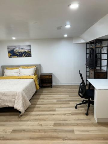 a bedroom with a bed and a desk and a desk at Toronto Cozy Home Retreat in Toronto