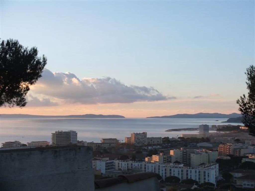 - une vue sur la ville et l'océan au coucher du soleil dans l'établissement Appartement T2 équipé avec terrasse et parking au Lavandou - FR-1-803-25, au Lavandou