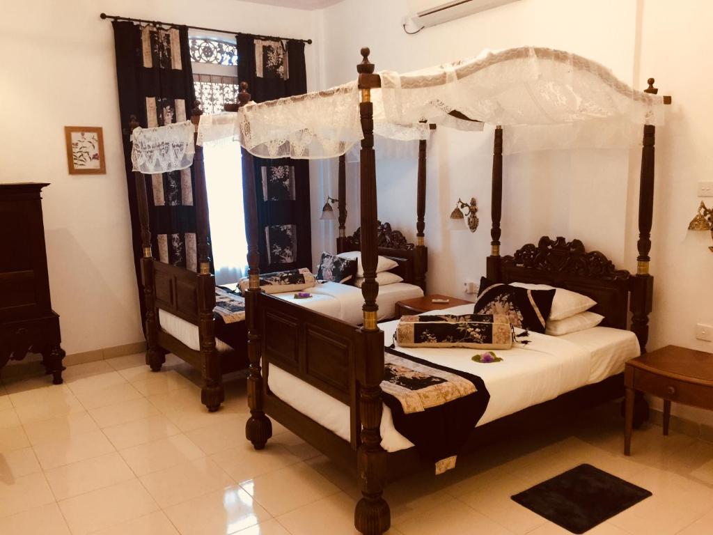 Postel nebo postele na pokoji v ubytování Manor House-Kandy