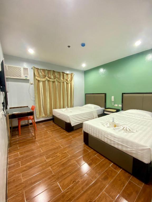 Postel nebo postele na pokoji v ubytování Asia Jem Hotel - BAYAWAN