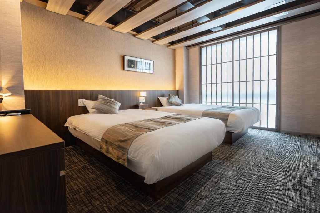 Postel nebo postele na pokoji v ubytování 谷町君Hotel Crush On 京都四条烏丸