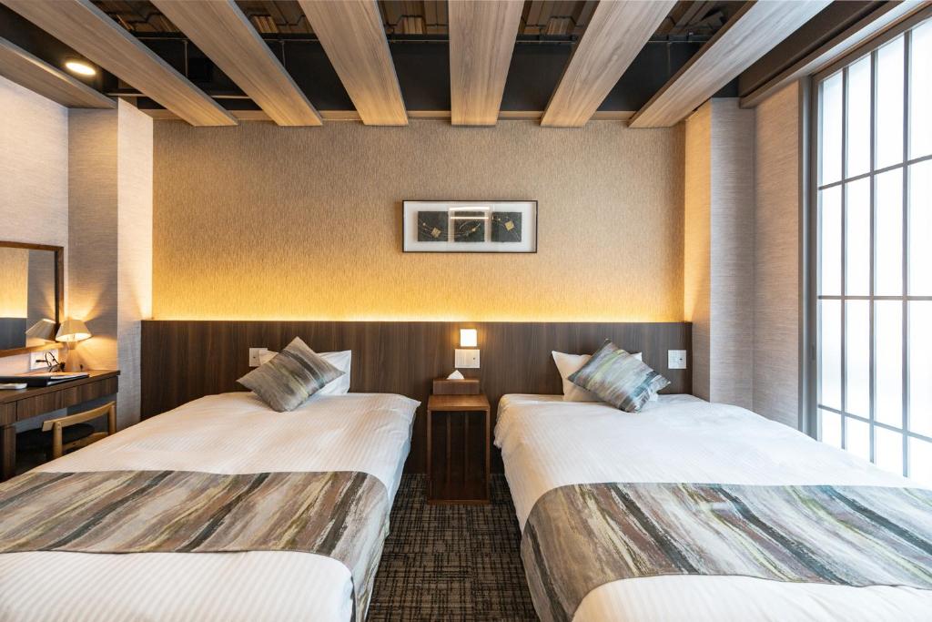 Postel nebo postele na pokoji v ubytování 谷町君Hotel Crush On 京都四条烏丸