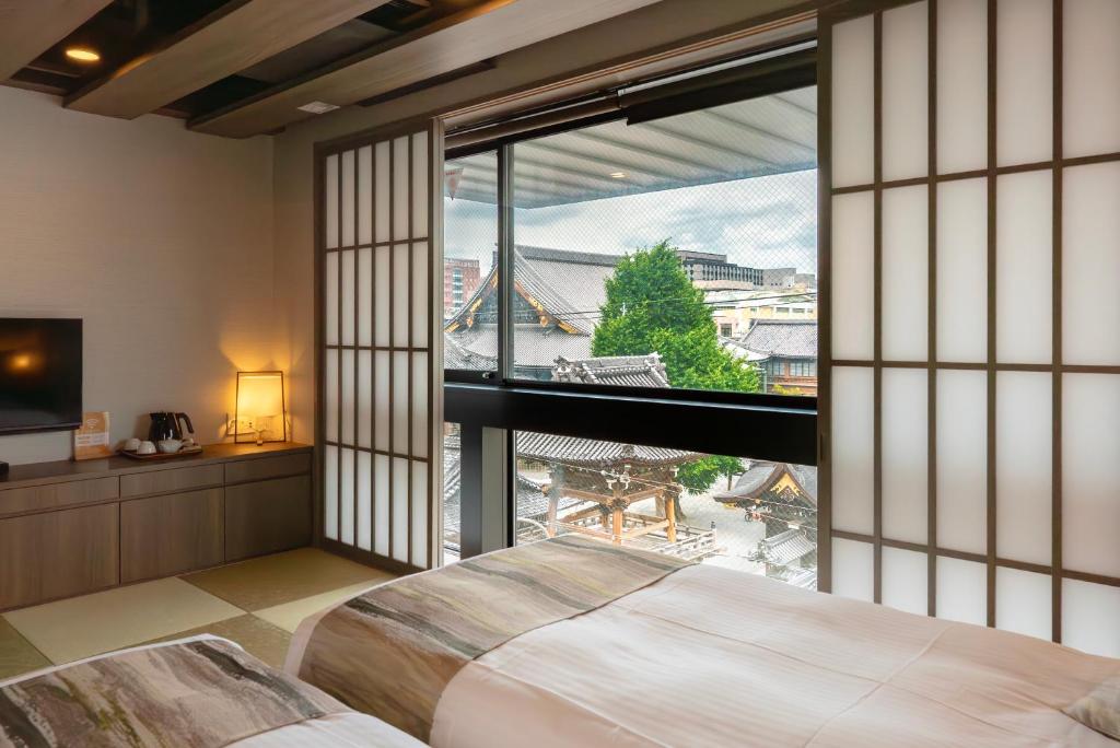Postel nebo postele na pokoji v ubytování 谷町君Hotel Crush On 京都四条烏丸