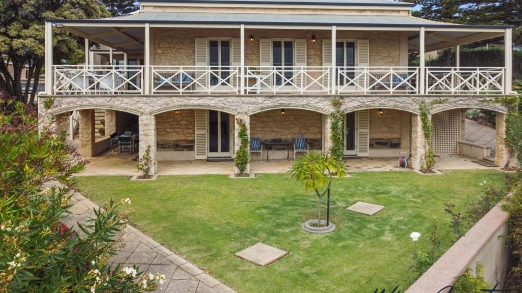 a house with a balcony on top of a yard at Alton House By Wine Coast Holidays in Port Willunga