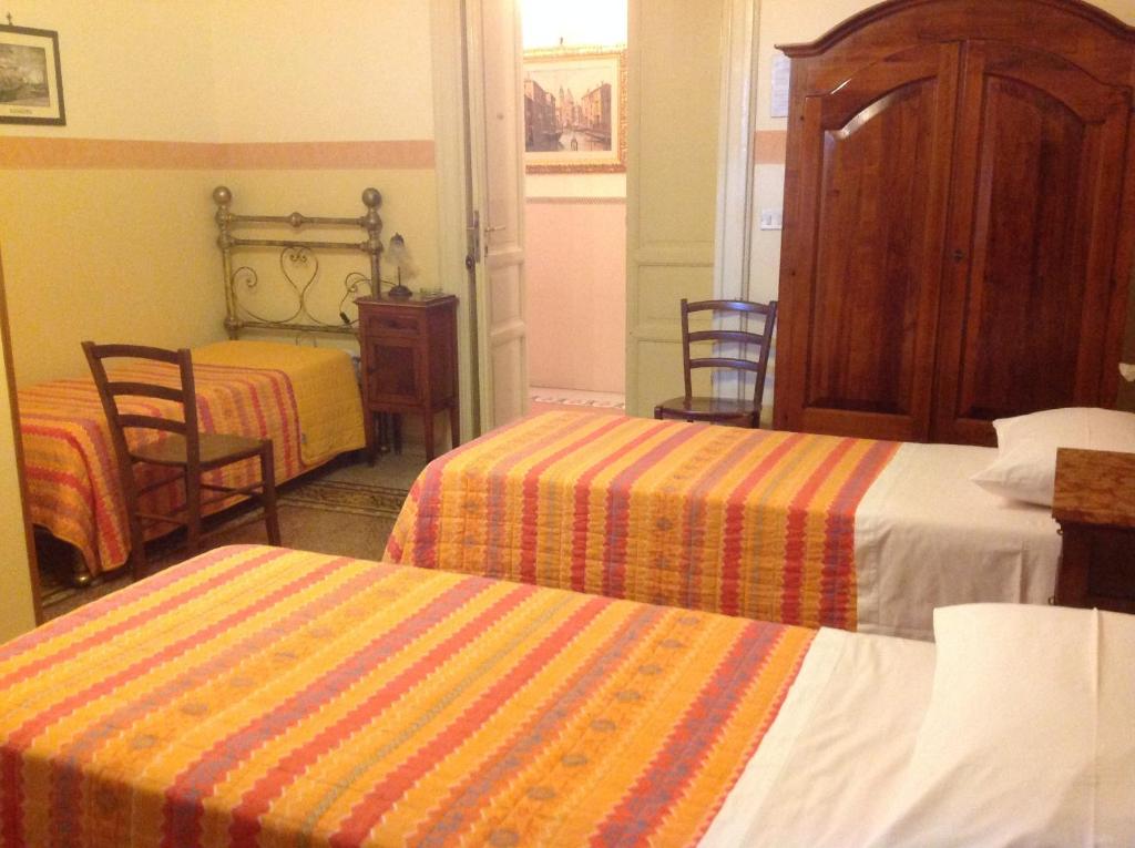 Postel nebo postele na pokoji v ubytování Albergo Cavour