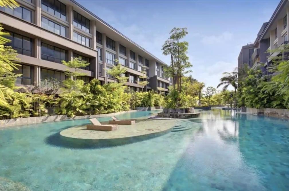 a swimming pool in front of a building at Anagata Tanjung Benoa Bali in Nusa Dua