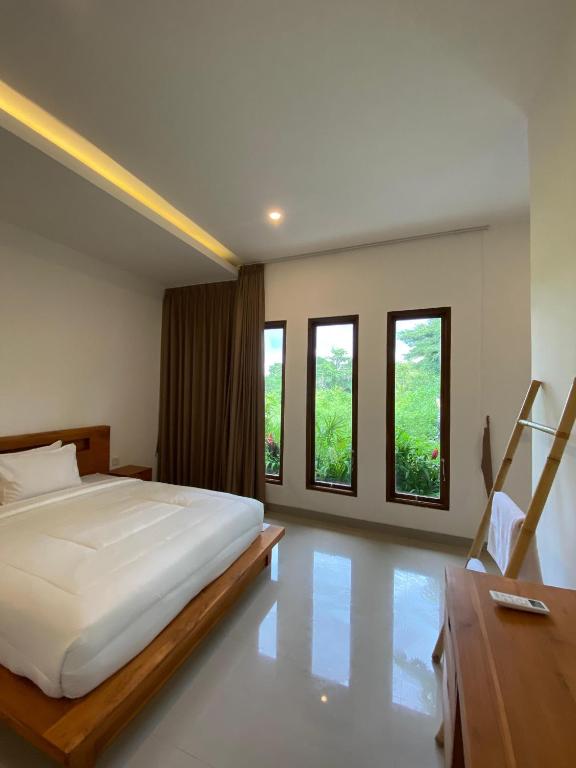 Postel nebo postele na pokoji v ubytování Kayom Rooms