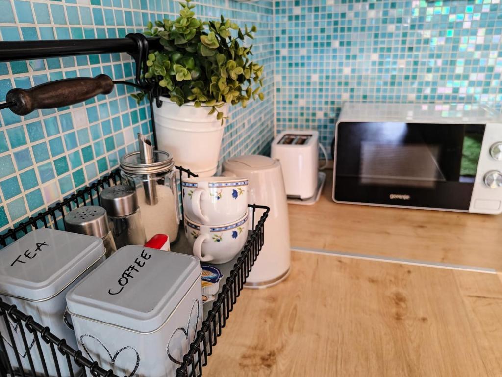 a kitchen with a counter with a microwave and appliances at Green City Apartment Budapest - FREE GARAGE, AC, BALCONY, WI-FI in Budapest