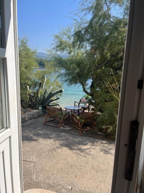 a patio with a table and chairs and the ocean at Casa Maja in Koločep