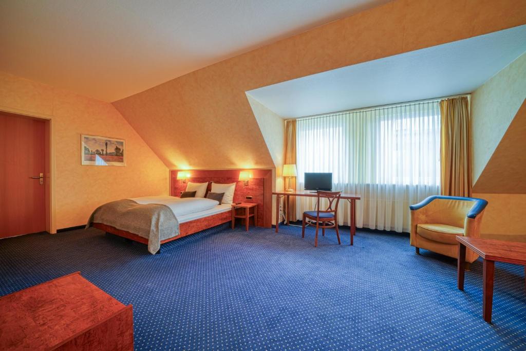Postel nebo postele na pokoji v ubytování Hotel Wissers Fehmarn