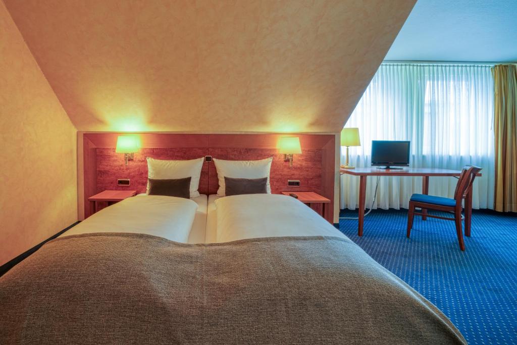 Postel nebo postele na pokoji v ubytování Hotel Wissers Fehmarn