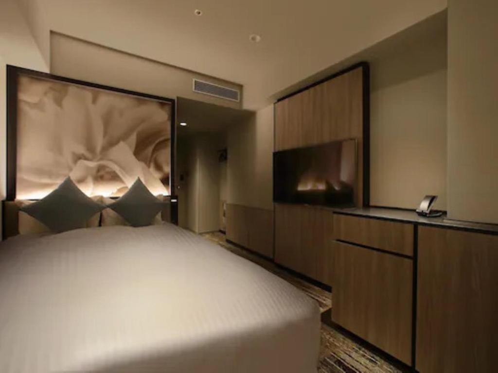 Postel nebo postele na pokoji v ubytování ORIENTAL HOTEL UNIVERSAL CITY