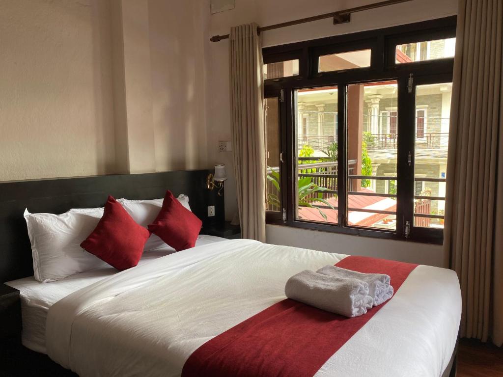 Llit o llits en una habitació de Hotel Nevis