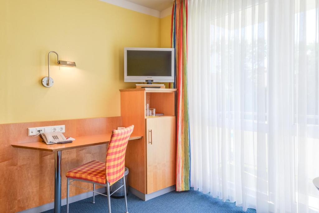 TV a/nebo společenská místnost v ubytování Hotel Beim Schrey