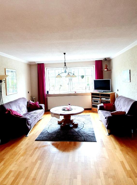 a living room with two couches and a coffee table at Ferienwohnung Am Gillrather Hof in Geilenkirchen