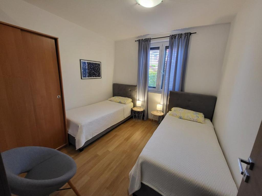 Posteľ alebo postele v izbe v ubytovaní Apartment Luciana