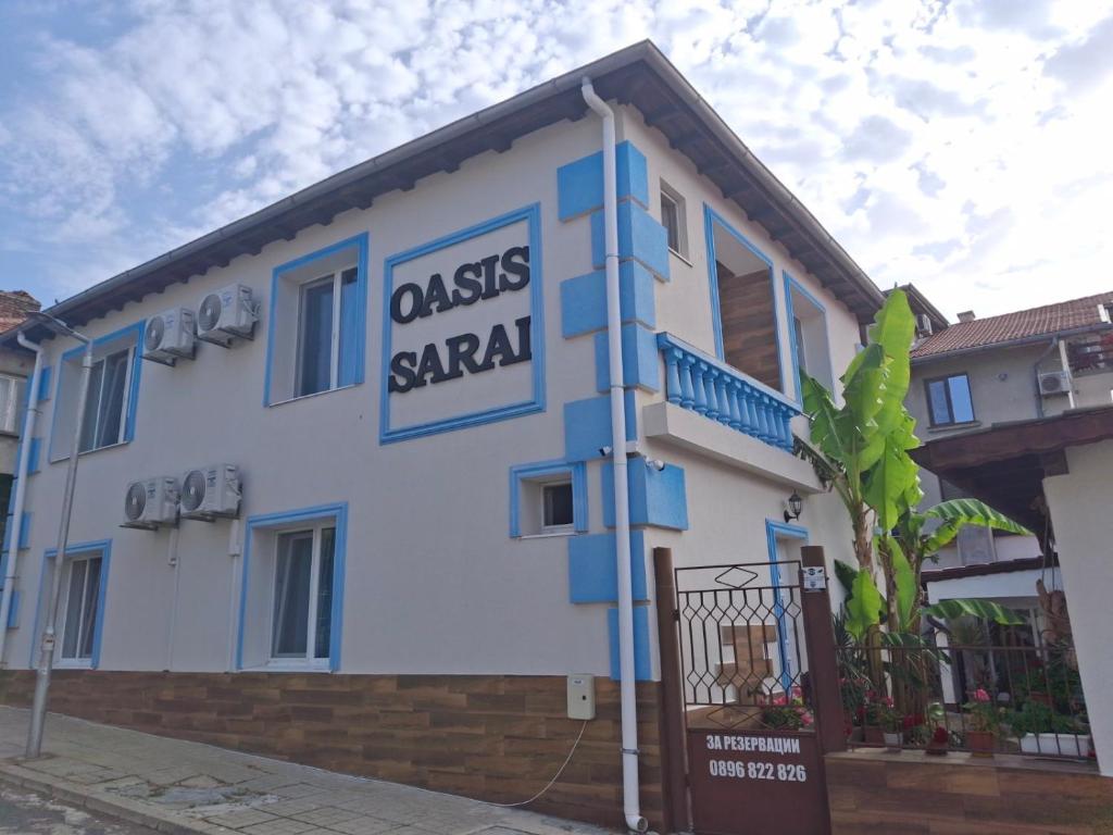 a building with a sign that reads casas saaq at Вила Оазис Сарай - Царево in Tsarevo