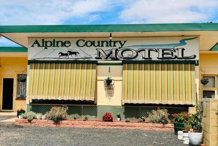 an alice county morrill building with a sign on it at ALPINE COUNTRY MOTEL plus FREE COFFEE in Cooma