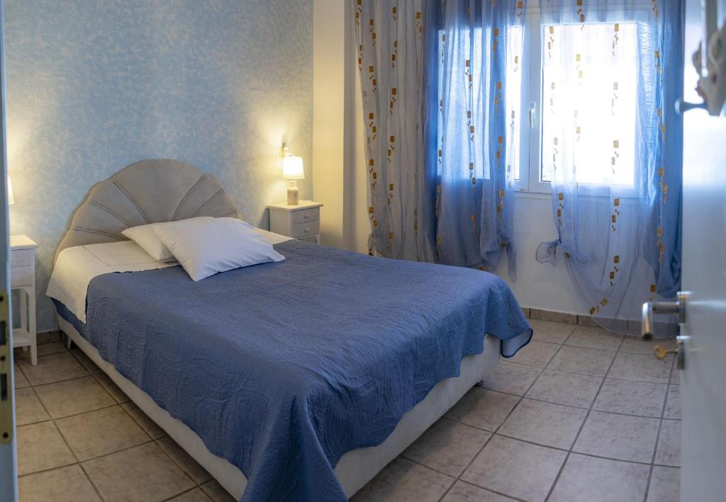 A bed or beds in a room at Shades of Blue