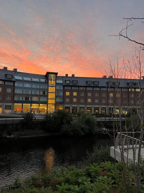 a building with a sunset in the background at Radisson Blu Hotel, Durham in Durham