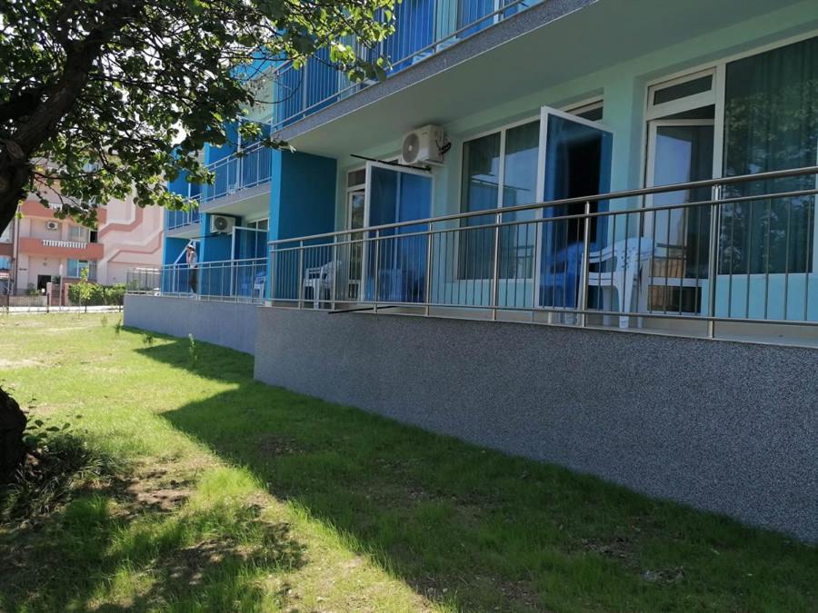 a blue building with balconies on the side of it at хотел Ропотамо in Primorsko