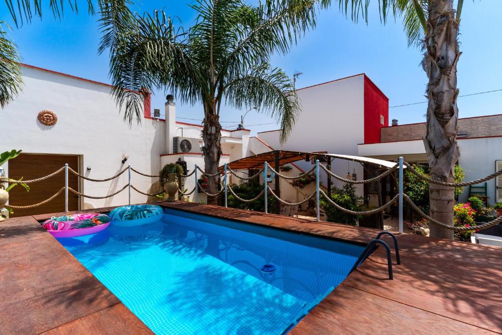 a swimming pool in the backyard of a house at Casa Venere Luxury Apartment in Giuggianello