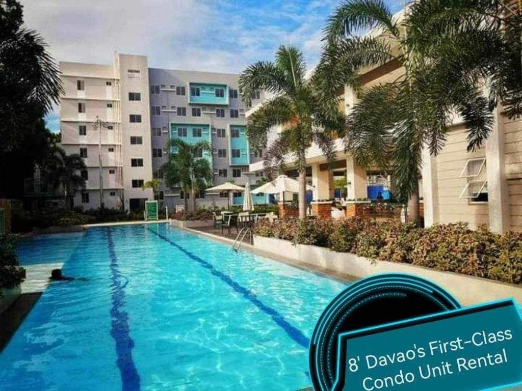 a large swimming pool in front of a building at 8's Davao's First-Class Condo Unit in Davao City