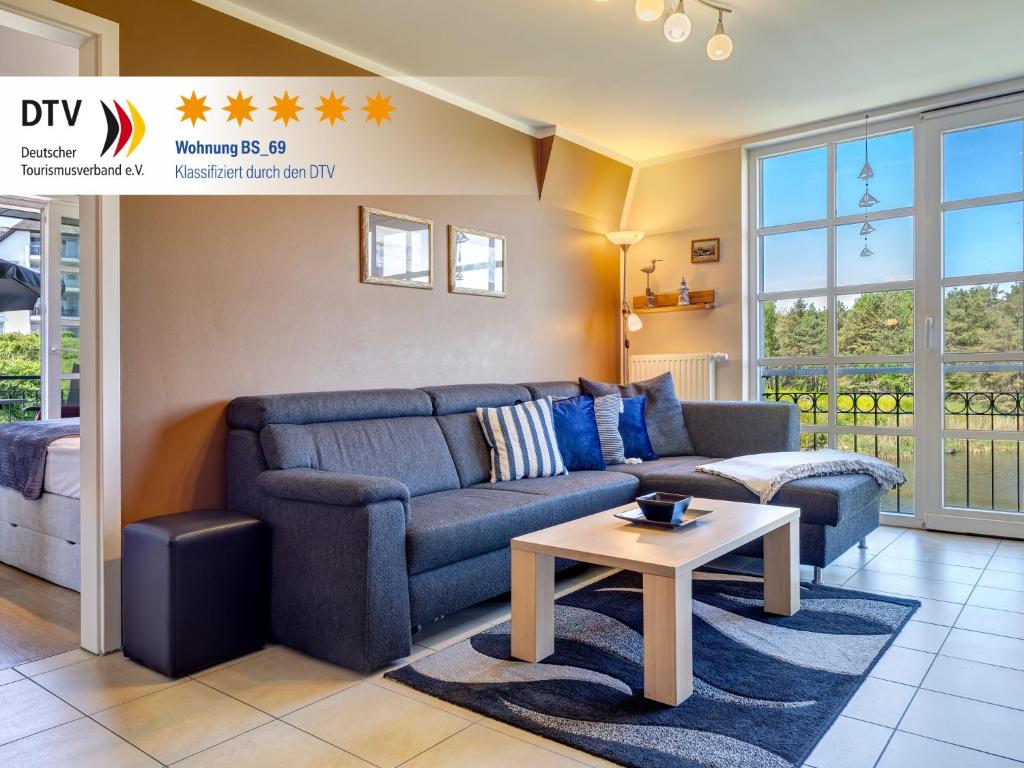 a living room with a couch and a table at Residenz am Balmer See - BS 69 mit Wellnessbereich in Balm