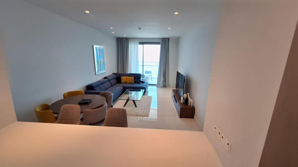 a living room with a couch and a table at Del Mar 2 Bedroom Deluxe Seaside 'A' Residence in Limassol