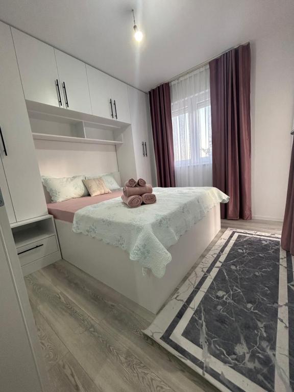 a bedroom with a bed with a towel on it at Sweet Holiday in Mostar