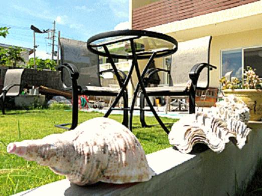 a sculpture of a statue of a sheep on a wall at Cha Villa in Zamami