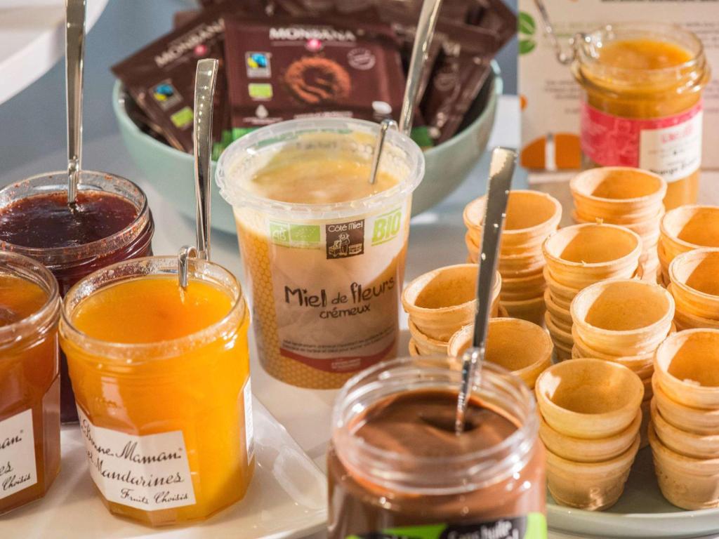 a table with jars of honey and jars of jam at Ibis Styles Nice Centre Gare in Nice