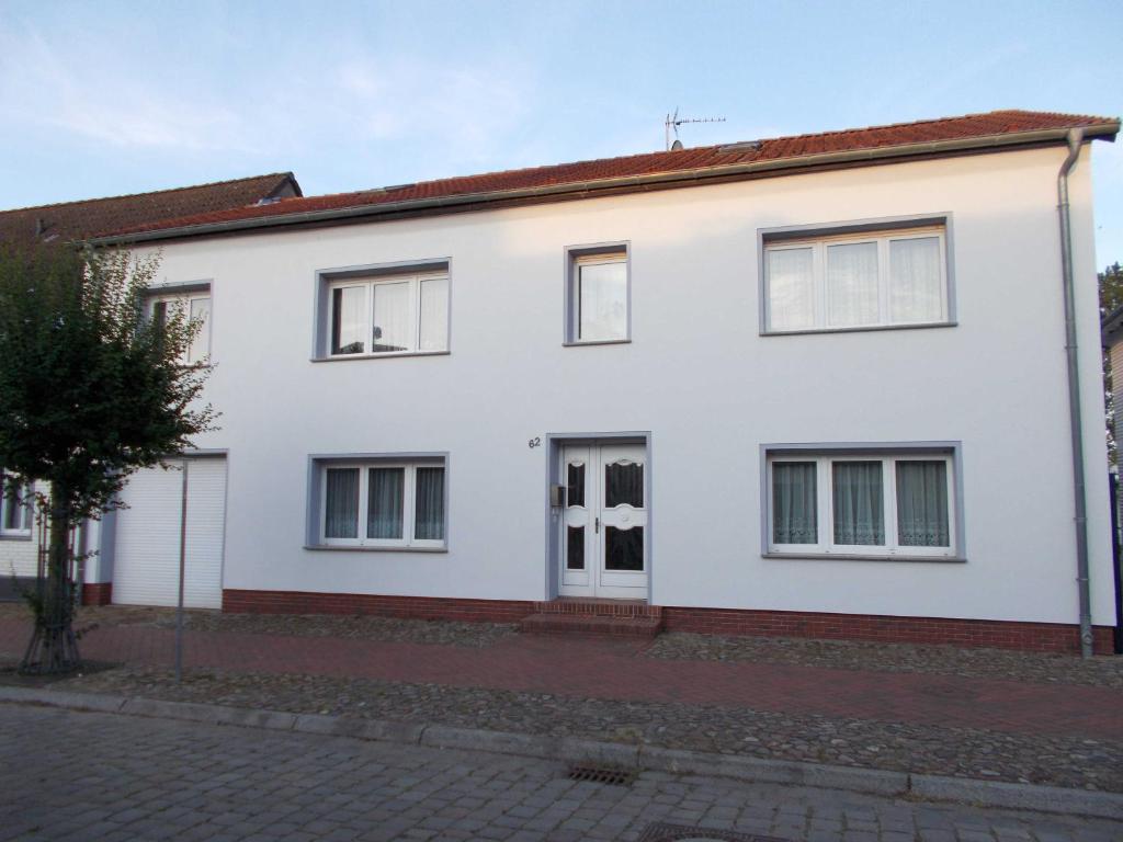 a white house with a red roof at Ferienwohnung in Usedom Town