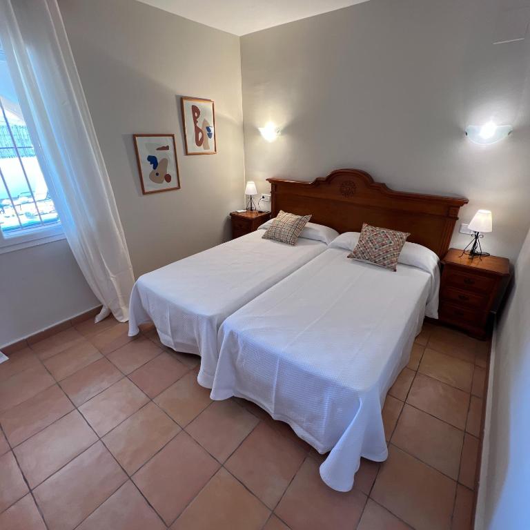 a bedroom with a large white bed in a room at Villas Monte Jávea - BTB in Jávea