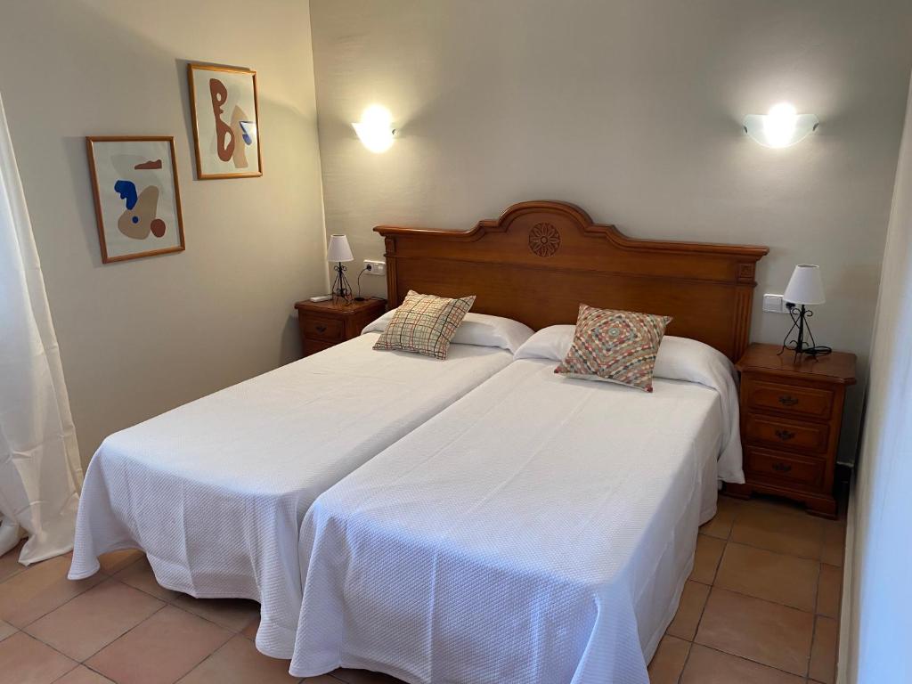 a bedroom with two beds with white sheets at Villas Monte Jávea - BTB in Jávea