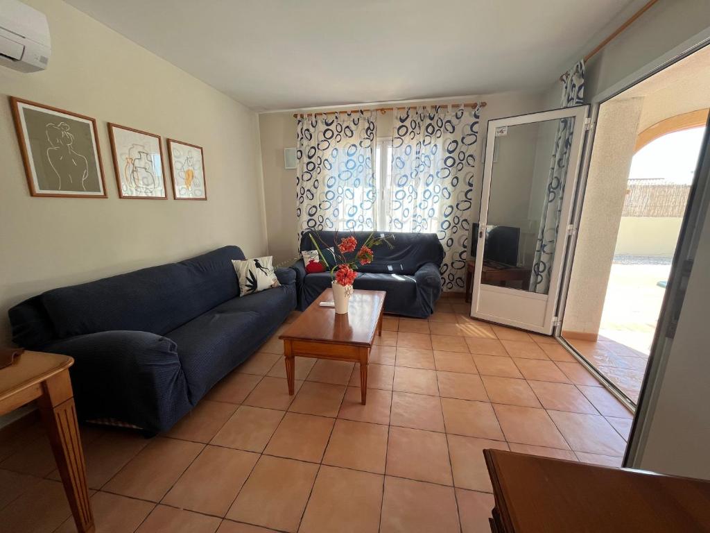 a living room with a couch and a table at Villas Monte Jávea - BTB in Jávea
