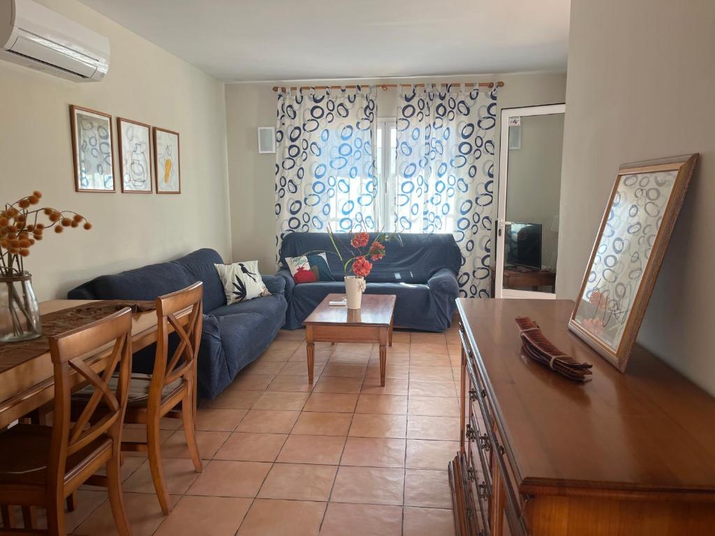 a living room with a blue couch and a table at Villas Monte Jávea - BTB in Jávea