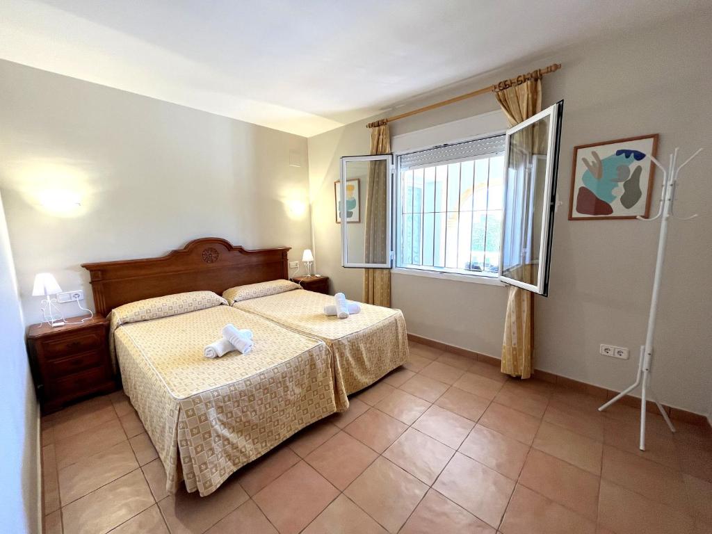 a bedroom with a bed and a window at Villas Monte Jávea - BTB in Jávea