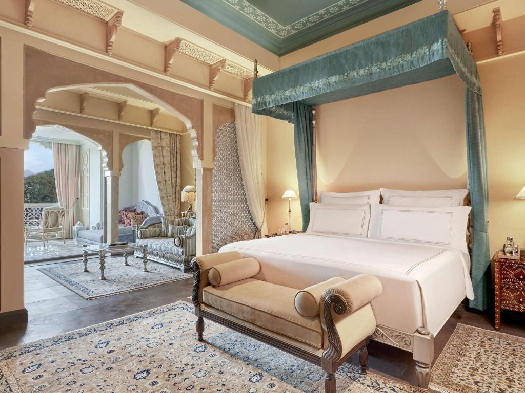 Postel nebo postele na pokoji v ubytování Raffles Jaipur
