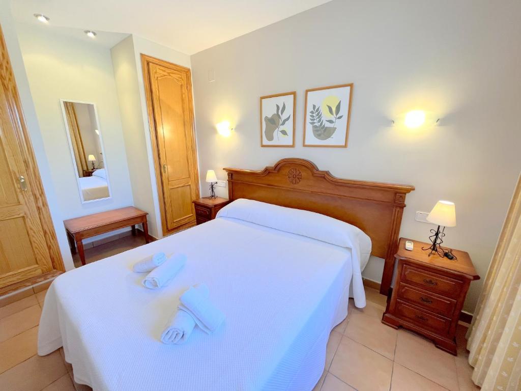 a bedroom with two beds with towels on them at Villas Monte Jávea - BTB in Jávea