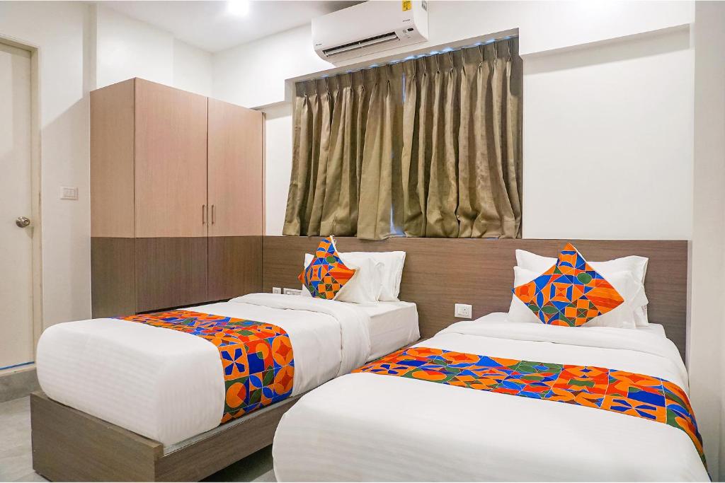 Postel nebo postele na pokoji v ubytování FabHotel Prime Athiti Delight Stay