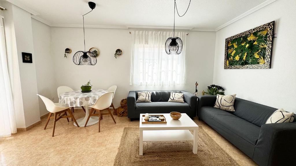 a living room with a couch and a table at Low Price Modern Apartment Aircon & Filter Water in San Pedro del Pinatar
